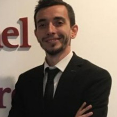 A man in a black suit with a beard.