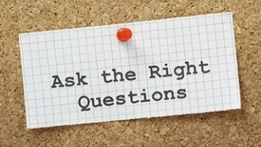Pinned note on corkboard with 'Ask the Right Questions'