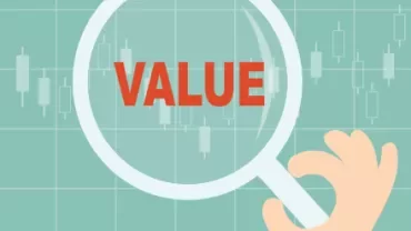Magnifying glass focusing on the word 'VALUE' over a stock chart.