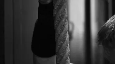 Hands gripping a rope.