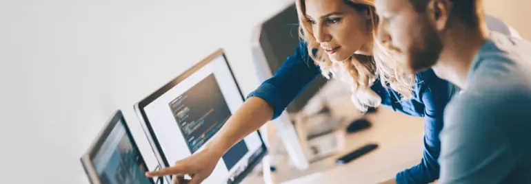 Two people looking at a computer screen