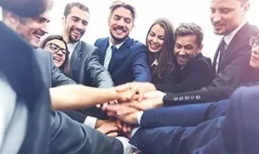 Business professionals uniting hands in team spirit.
