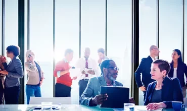 People talking and interacting in a business meeting.