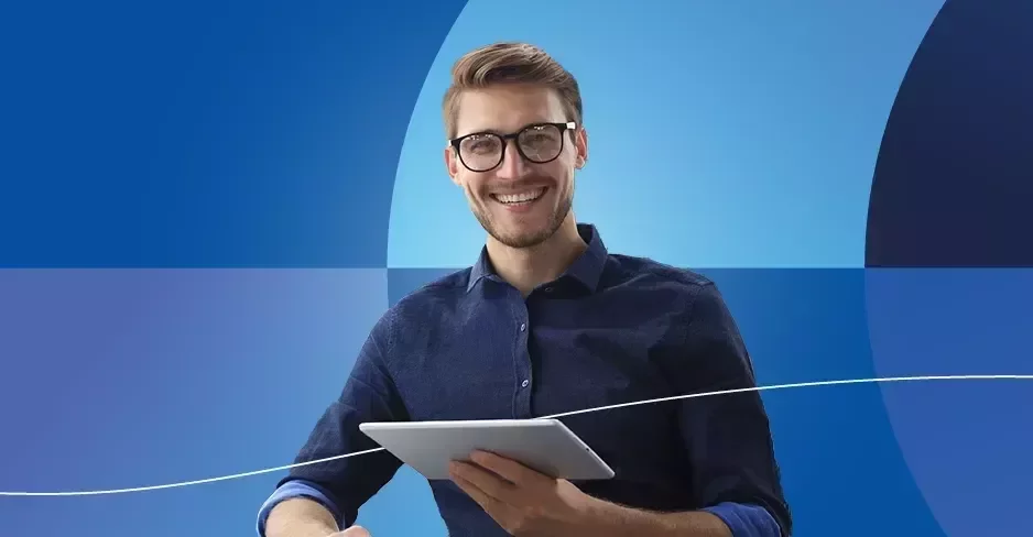 a smiling man with a tablet on a blue background