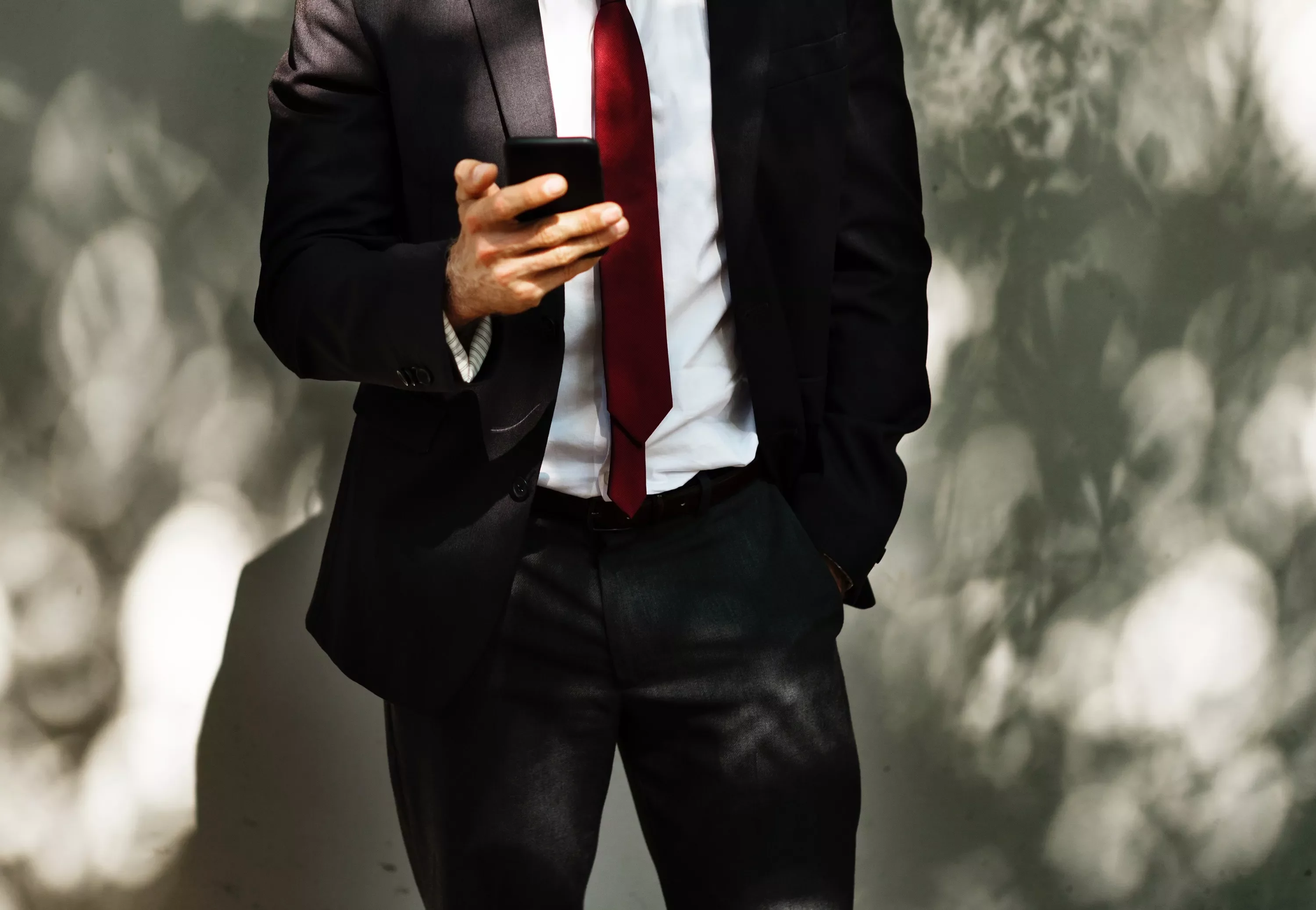 Man in suit looking at smartphone