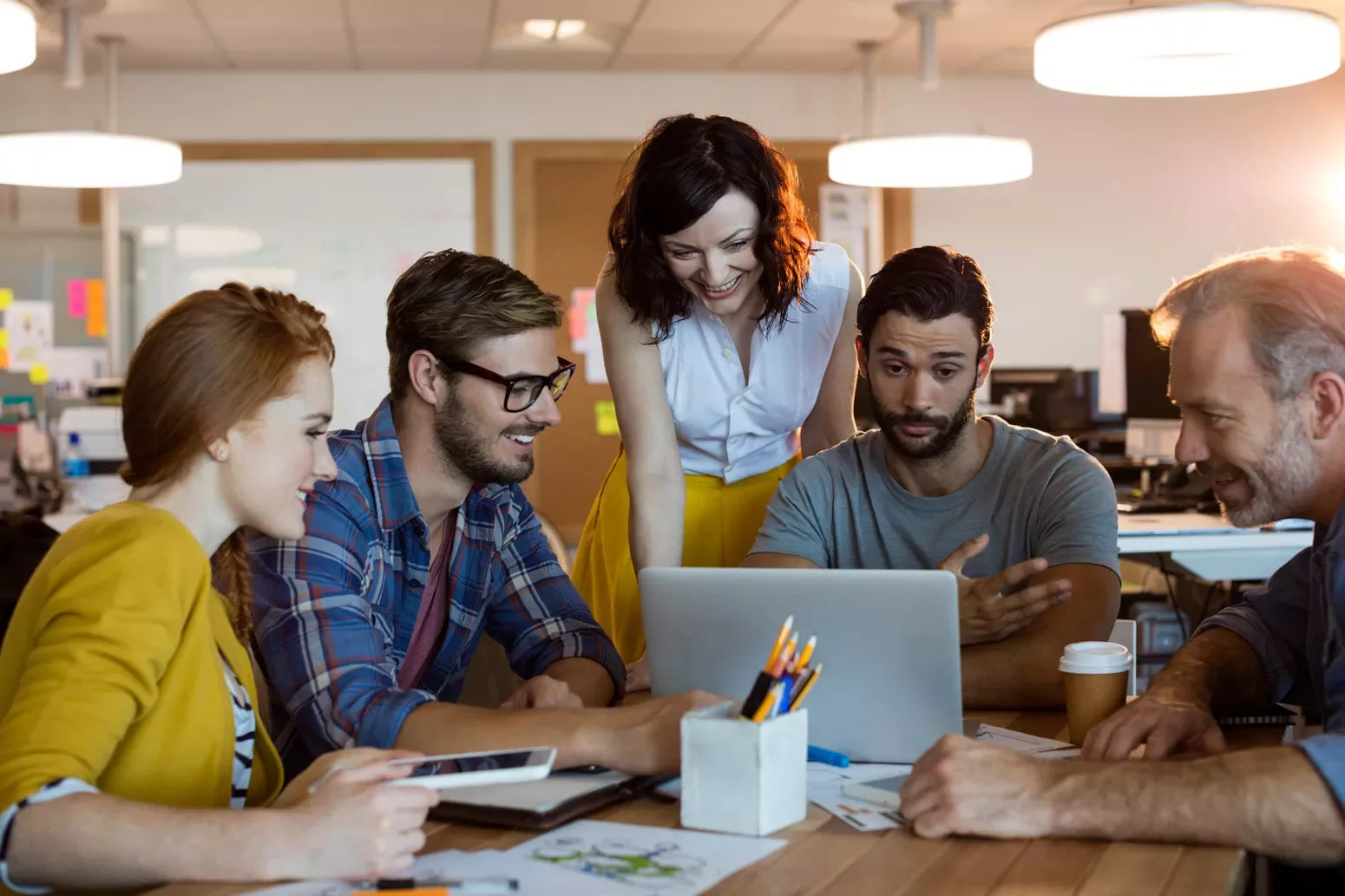 A group of people working together at a laptop.