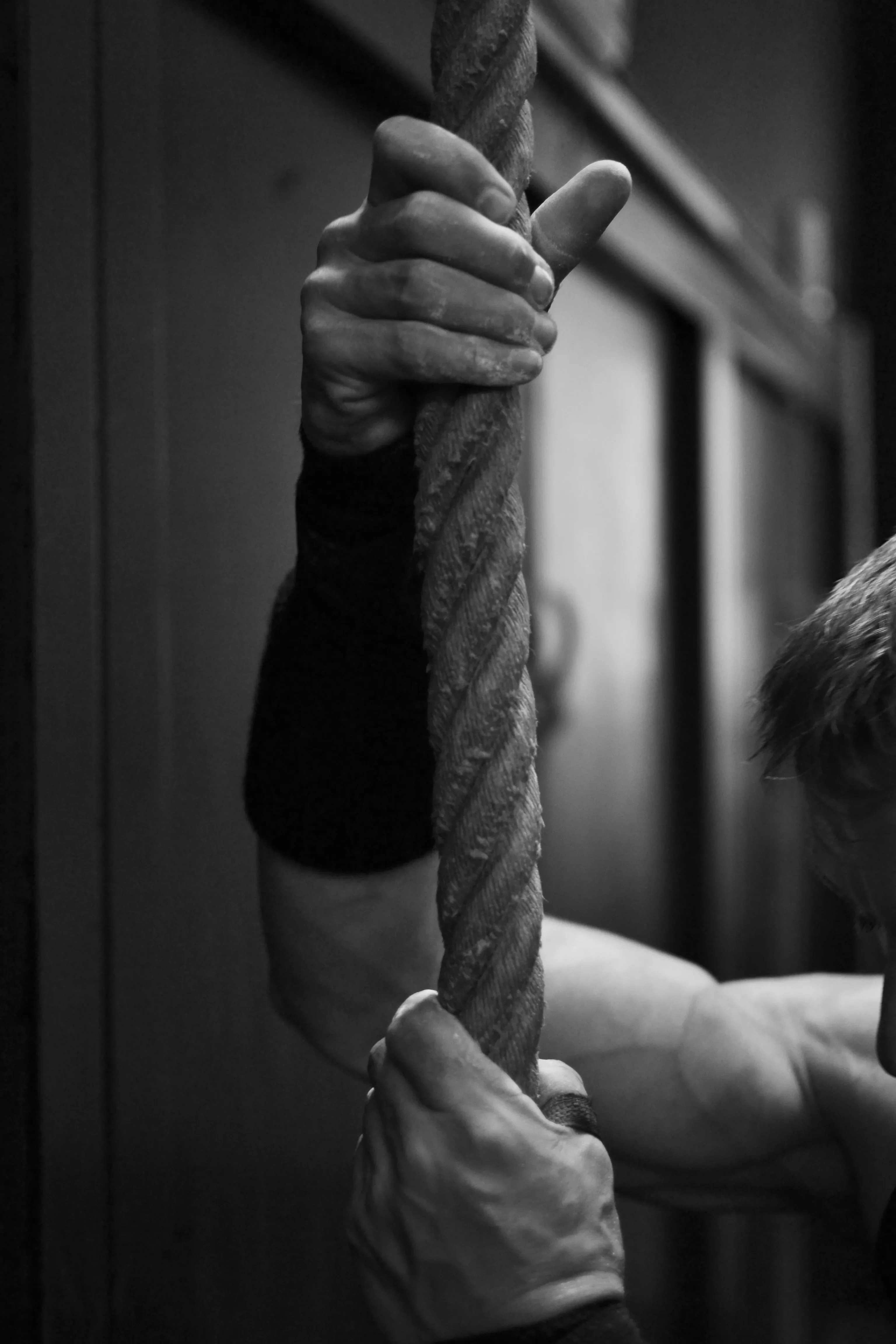 Hands gripping a rope.